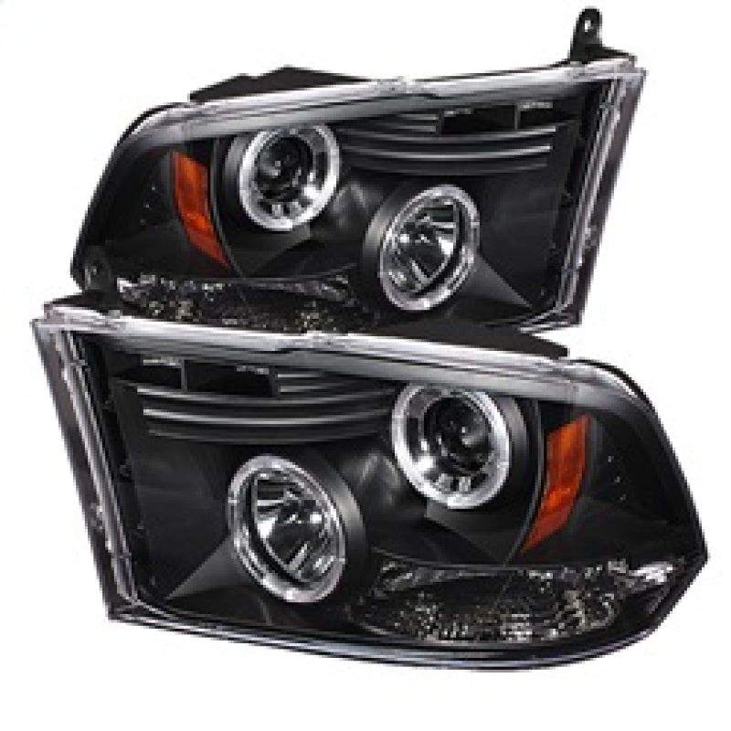 Spyder projector headlights for Dodge Ram 1500, 2009-2014, with halogen and LED halo, black design.